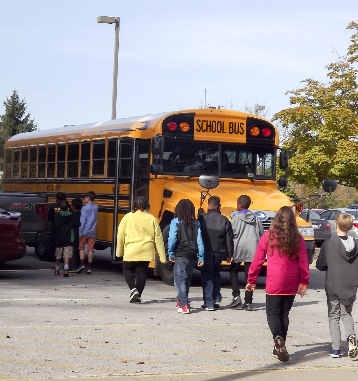students walking to school bus