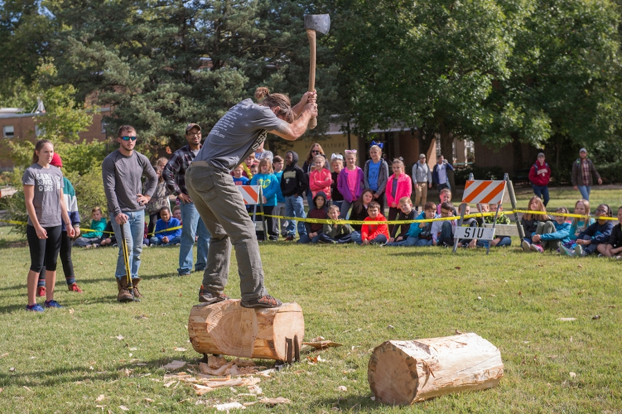 fourth graders watching log cutting demonstration