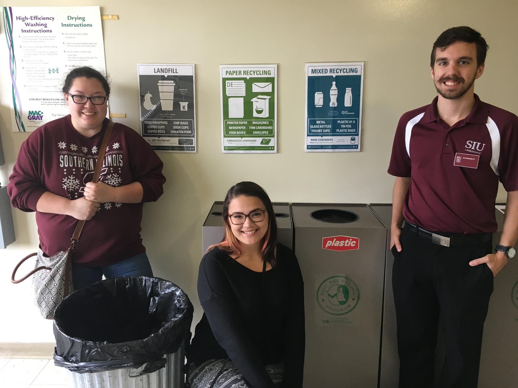 3 AIGA Students In Front Of Recycling Bins