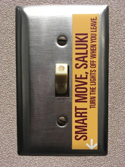 "Smart Move, saluki, turn the lights off when you leave" sticker on light switch