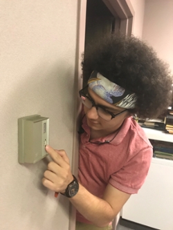 Andrew adjusting thermostat