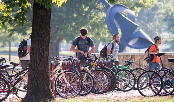 students bike on campus