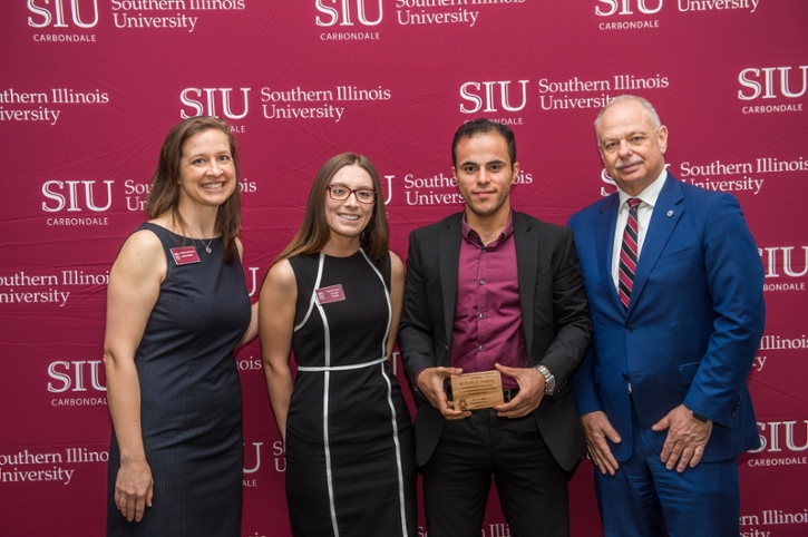 Ali Alruzuq receiving their award