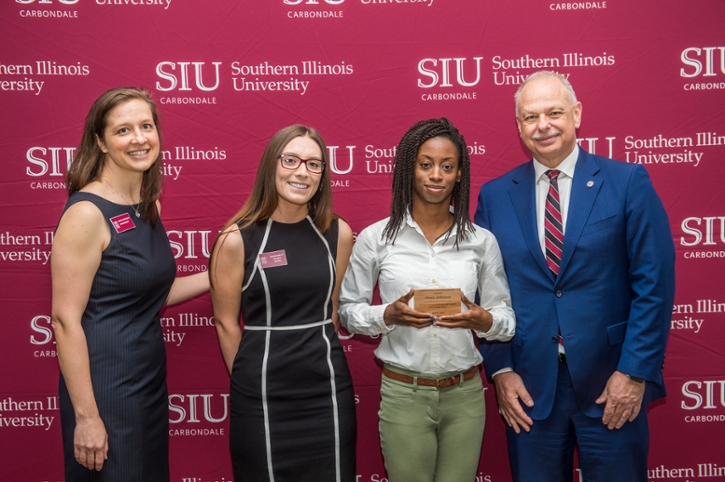 Alexis Johnson receiving their award