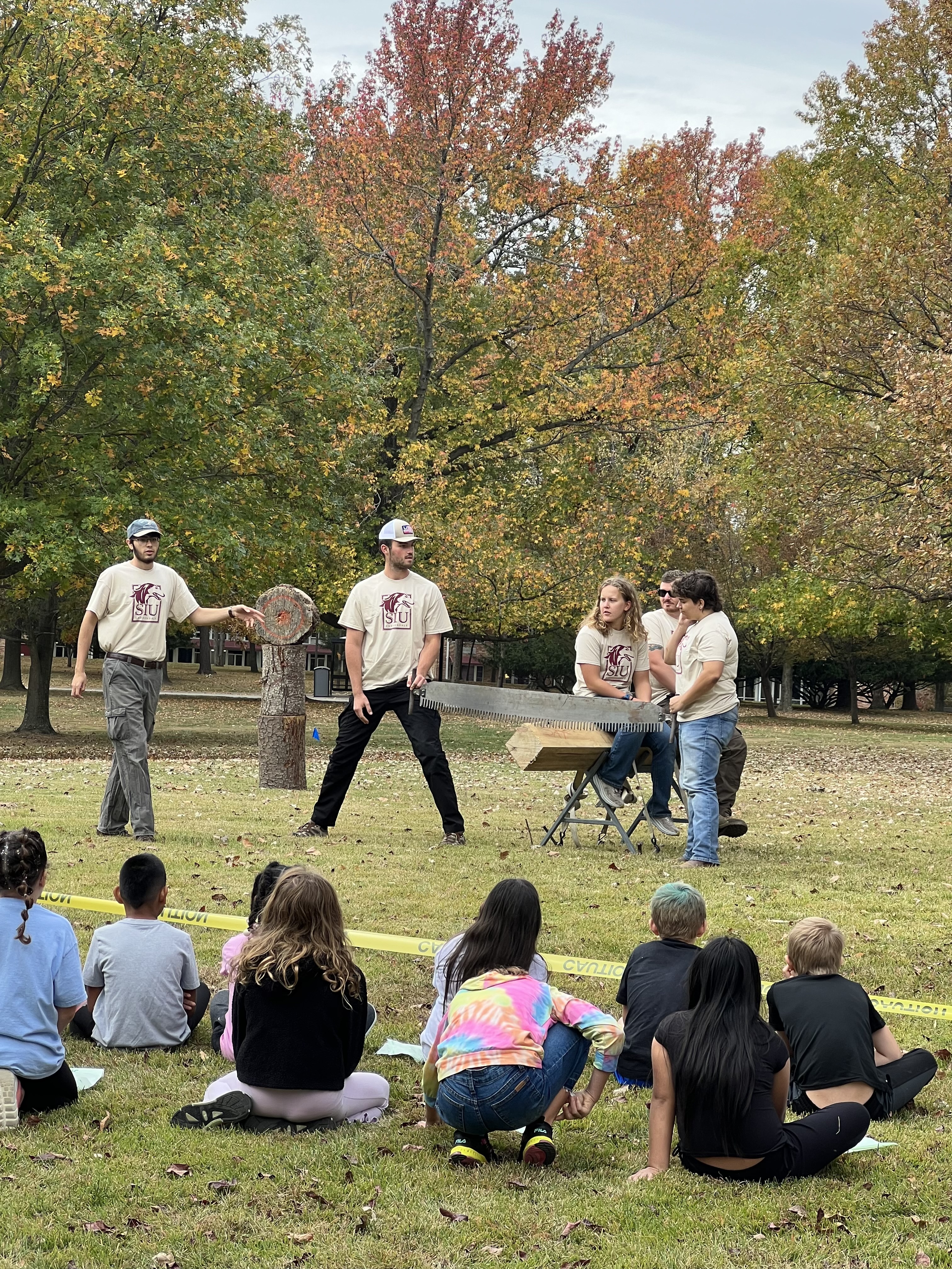 SIU logging demonstration with crowd