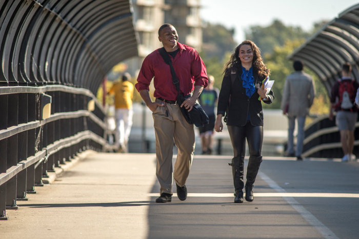 students walk on campus overpass